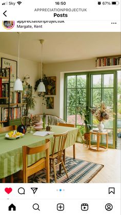 an image of a table and chairs in a room with bookshelves on the wall