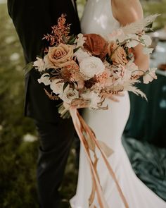 a bride and groom standing next to each other