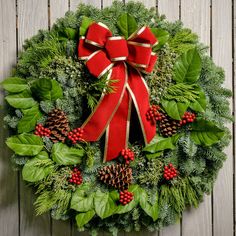 Christmas wreath of noble, cedar, juniper and salal with pine cones, red bow with gold edges and red berry clusters close up Fresh Pine Wreath, 2022 Gifts, Wreath With Bow, Holiday Berries, Fresh Wreath, Window Wreath, Fall Thanksgiving Wreaths, Red Wreath, Holly Wreath