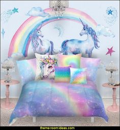 a bed with two unicorns on it in front of a rainbow wall