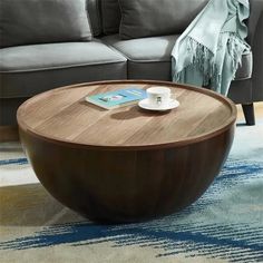 a coffee table sitting on top of a rug next to a couch