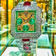 This captivating piece, part of the Dazzle Time collection, showcases an opulent digital interpretation of a luxury watch, adorned with vibrant emeralds, diamonds, and rubies. The intricate design of the watch face and bracelet reflects the blend of high fashion and futuristic elegance, using bold, precious materials to convey both grandeur and sophistication. The shimmering gemstones and sleek design evoke a sense of wealth and exclusivity, making this piece an alluring statement of luxury. Welcome to my high-concept art for the wall, shelf, Digital Picture frame, or computer desktop wallpaper.  Art Description: Emerald Horizon is a digital masterpiece that reimagines the traditional timepiece into an artwork of extraordinary opulence. Set in a framework of sparkling diamonds, the watch f Luxury Bling Diamond Watch For Party, Luxury Party Watches With Subdials, Luxury Watches With Subdials For Parties, Elegant Green Watch As A Gift, Elegant Green Watch For Gift, Luxury Formal Watch With Bling, Luxury Bling Watch For Formal Occasions, Luxury Bling Watches For Formal Occasions, Designer Green Watches For Formal Occasions