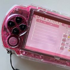 a close up of a pink game controller