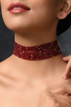 Red Stones Choker Necklace Length - 14 inches DETAILS -100% top Quality -22K gold plated silver copper alloy. -Handcrafted in our all girls workshop in Paisley Pop Studio, Jammu and Kashmir STYLE TIP A simple even dull outfit will almost always look transformed into something special with the right jewellery and accessories. You can choose this choker necklace to bring a simple outfit to life. This look perfect when you are wearing a traditional or indo-western outfit. Handcrafted in Jammu and K Adjustable Yellow Gold Ruby Jewelry, Yellow Gold Ruby Bead Jewelry, Yellow Gold Jewelry With Round Beads For Party, Handmade Ruby Temple Jewelry, Gold Ruby Round Bead Necklaces, Plated Choker Jewelry For Gifts, Gold Beaded Ruby Necklace, Gold Ruby Beaded Necklace, Plated Choker Jewelry Gift