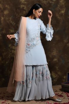 Powder blue floral embroidered kurta with sequin detail. Paired with embroidered palazzo and dupatta.
Component: 3
Pattern: Embroidered
Type Of Work: Thread work, Cutdana work, Mirror work
Neckline: Round
Sleeve Type: Full sleeves
Fabric: Georgette, Net
Color: Blue
Other Details: 
Peach dupatta
Ruffle sleeves
Occasion: Wedding, Reception - Aza Fashions Semi-stitched Embellished Blue Blouse Piece, Party Palazzo Set With Floral Embroidery In Georgette, Party Semi-stitched Sharara With Floral Embroidery, Party Sharara With Floral Embroidery And Semi-stitched Fit, Semi-stitched Embellished Georgette Kurta, Embellished Semi-stitched Georgette Kurta, Eid Sets With Floral Embroidery In Georgette, Eid Georgette Sets With Floral Embroidery, Eid Floral Embroidered Palazzo Set