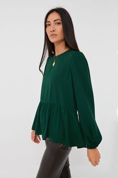 Flowy and flattering, the Carlota Peplum Blouse is a wardrobe must-have. This top features puff sleeves with elasticated wrists, keyhole button back closure, high-low silhouette, and a peplum hem detail. Pair with denim and flats for casual Friday in the office, then opt for leather leggings and a chic bag for a night on the town with your besties or a romantic date! Crew neckline Long puff sleeves Elasticated cuffs High-low Peplum hem detail Material: 100% Polyester Care: Hand wash cold Chic Green Top With Elastic Sleeves, Workwear Blouse With Ruffle Hem And Puff Sleeves, Peplum Blouse With Ruffle Hem For Work, Green Blouson Sleeve Blouse For Work, Green Blouse With Blouson Sleeves For Work, Plus And Minus, Chic Bags, Peplum Blouse, Peplum Hem