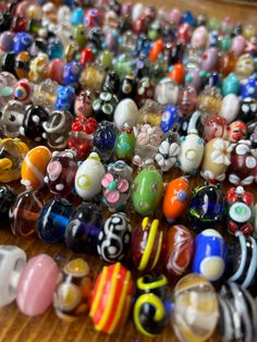 many different colored glass beads on a table