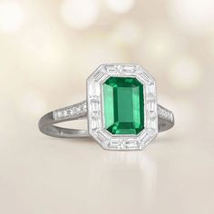 A Lively Halo Engagement Ring Featuring A 1.54 Carat Emerald-Cut Natural Green Emerald. Emerald And Diamond Ring Vintage, Green Emerald Cut Halo Ring In Platinum, Green Emerald-cut Platinum Halo Ring, Platinum Emerald Cut Emerald Ring With Halo Design, Emerald-cut Platinum Halo Ring, Gia Certified Emerald Cut Halo Ring, Emerald Cut Platinum Halo Ring, Platinum Emerald Ring With Baguette Cut And Halo Setting, Baguette Cut Emerald Ring With Halo Setting In Platinum