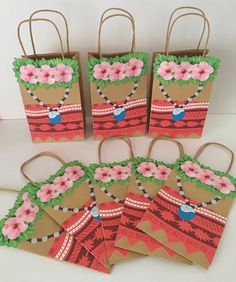 six small bags with flowers on them sitting next to some other paper bag designs and decorations