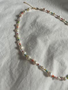 The Rainbow Pearl Necklace is made with freshwater pearls and colorful seed beads on strong silkon thread. We advise not wearing this piece in water. Necklace is 16" with a 2" gold-filled extender. All orders over $75 will include a free gift box. Water Necklace, Sweater Pin, Rainbow Pearl, Instagram Shop, In Water, The Rainbow, Shop Necklaces, Free Gift, Necklaces Bracelets