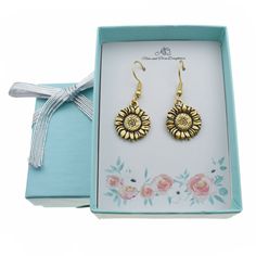 Our sunflower earrings are the perfect gift for any occasion! These earrings would make a wonderful Birthday, Christmas, Valentines Day, or anniversary gift for any special lady in your life! These cute earrings are made of 24K gold plated pewter on stainless steel wires. Stainless steel is a wonderful metal for earring wires because it is hypoallergenic and can be worn by most people. Size: one size.  Gender: female.  Age Group: adult. Yellow Gold Birth Flower Earrings Gift, Gold Birth Flower Earrings For Gift, Gold Birth Flower Shaped Earrings, Gold Birth Flower Earrings For Anniversary, Gold Earrings With Birth Flower For Anniversary, Flower Charm Earrings For Mother's Day Anniversary, Flower Charm Earrings For Anniversary And Mother's Day, Flower Charm Earrings For Anniversary On Mother's Day, Nickel-free Earrings For Mother's Day Gift