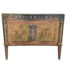 an old wooden cabinet with decorative designs on it