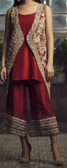 The gorgeous jacket style is an uplifting look for any formal occasion. Shining sequins, crystal and pearls are delicately placed by hand onto the silver tilla worked blooms. It is paired with a silk trouser with hand embellishments at the bottom.  Color: Red Includes: Shirt/Jacket Trouser Elegant Set With Pearl Embroidery For Reception, Elegant Sets With Pearl Embroidery And Traditional Drape, Elegant Sets With Pearl Embroidery For Reception, Red Sequined Wedding Set, Elegant Embellished Sets For Festive Season, Red Wedding Sets With Sequins, Elegant Embellished Evening Sets, Elegant Party Sets With Pearl Embroidery, Glamorous Festive Silk Sets