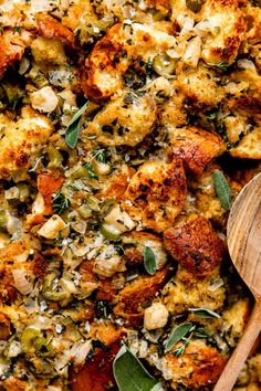 a casserole dish with stuffing and fresh herbs on the side, ready to be eaten