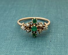 Antique natural emerald, pearl and diamond ring. Solid yellow gold ring is not hallmarked but tests as 14K. Very good antique condition. Current finger size is 6. Sizing can increase delivery up to 2 weeks.  (2) 2.0mm old mine cut diamonds, seed pearls and three small natural emeralds. Happy to answer any questions pre purchase. Gross weight of ring is 1.54 pennyweight. Antique Emerald Ring, Seed Pearl Ring, Pearl And Diamond Ring, Etsy Gold Ring, Victorian Rings, Diy Rings, Seed Pearl, Gothic Jewelry, Yellow Gold Ring