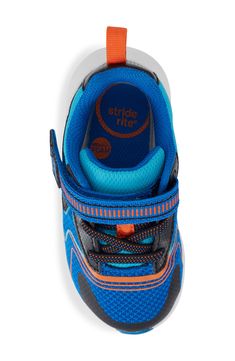 Put a cosmic twinkle in your kiddo's step with this light-up athletic sneaker with a memory foam footbed, hook-and-loop closure and padded collar. Adjustable hook-and-loop closure with elastic laces OrthoLite® footbed Textile and synthetic upper/recycled-textile lining/rubber sole Imported American Podiatric Medical Association (APMA) Seal of Acceptance Blue Scratch-resistant Running Shoes For Training, Blue Sporty Scratch-resistant Running Shoes, Scratch-resistant Blue Sneakers For Training, Blue Scratch-resistant Sporty Running Shoes, Blue Scratch-resistant Running Shoes, Blue Scratch-resistant Running Shoes For Light Sports, Blue Scratch-resistant Sneakers For Light Sports, Elastic Laces, Athletic Sneakers