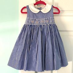 Beautiful Blue And White Striped Dress. Smocking With Precious Floral Embroidery. Buttons Down The Back With A Bow. Fully Lined. New With Tags! Reasonable Offers Considered. No Trades. Blue Embroidered Cotton Smocked Dress, Cute White Ralph Lauren Dress, Cute Blue Dress With Smocked Back, Cute Ruffled Ralph Lauren Dresses, Cute Ralph Lauren Dress With Ruffles, Embroidery Buttons, Blue And White Striped Dress, Ralph Lauren Baby Girl, Kid Clothes