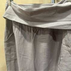 the bottom half of a pair of pants hanging on a clothes rack