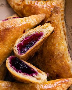 several pastries are stacked on top of each other with blueberry sauce in the middle