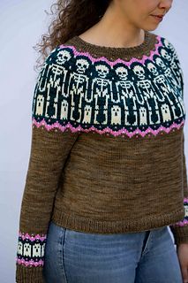 a woman wearing a sweater with skulls on it