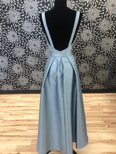 This satin dress with a high neck and low back is casual yet sophisticated. This gown is a size 12. The measurements are: Bust-38.5, Waist-30.5, and Hip-40.5. Please see our Sizing Section for questions on how to measure. This gown is a sample and may show signs of shop-wear. For a full list of what shop-wear may include please click here and see question number 2. Satin Dress With Pleated Back For Prom, Satin Party Gown With Pleated Back, Backless Satin Dress For Prom Season, Formal Satin Gown With Back Zipper, Formal Satin Evening Dress With Back Zipper, Satin Evening Dress With Back Zipper And Fitted Bodice, Satin Evening Dress With Fitted Bodice And Back Zipper, Fitted Satin Evening Dress With Back Zipper, Formal Backless Satin Dress With Back Opening