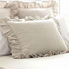 pillows with ruffled edges on a bed