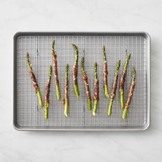 asparagus spears on a baking sheet ready to be cooked in the oven for dinner