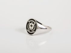 Coat of Arms jewelry - Family Crest Ring for Men ~ Customization included in purchase with your name or text on upper and lower ribbon, as preferred. Leave your note on chekcout. ✪ Classic Elegant design for men appearance with black enamel filling at face. ☛ Ring size as preferred, as it is custom created for you in our workshop. (select your ideal one in drop down menu) ☛ Custom design inside ring with your own personalized logo / pattern / symbol is possible. Contact us now! ❏ Material: ✪ Rin Classic Oval Hallmarked Enamel Ring, Classic Enamel Ring Gift, Classic Enamel Ring As Gift, Classic Oval Enamel Ring For Gift, Classic Polished Enamel Ring For Gift, Classic Enamel Ring With Polished Finish, Classic Enamel Ring With Polished Finish As A Gift, Oval Hallmarked Signet Ring For Commemoration, Classic Round Enamel Ring With Polished Finish