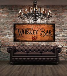 a living room with a couch, chandelier and wooden sign that says morgan's whiskey bar