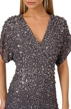 Glimmering embellishment details bring party-ready energy to this dolman-sleeve cocktail dress. 36" length Back zip closure Surplice V-neck Short sleeves Lined, except sleeves 50% viscose, 35% nylon, 15% metallic fibers Spot clean Imported Holiday V-neck Embellished Sequin Dress, Sparkling Sequin V-neck Dress For Evening, Silver Embellished V-neck Evening Dress, Festive Embellished V-neck Sequin Dress, Festive V-neck Embellished Sequin Dress, Embellished V-neck Sequin Cocktail Dress, Cocktail Sequin V-neck Dress, Festive Evening Sequin Dress With Short Sleeves, Embellished Sequin V-neck Evening Dress