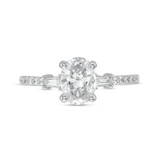 A stunning classic, this diamond engagement ring sets the stage for your happily ever after. Fashioned in platinum, this design showcases a 1 ct. certified oval-shaped diamond boasting a color rank of I and clarity of Si2. Tapered baguette-cut diamonds punctuate the diamond-lined shank. Captivating with 1-1/5 cts. t.w. of diamonds and a bright polished shine, this engagement ring will sparkle as long as your forever love. This style arrives with a certificate that includes a photo and a description of the diamond, which guarantees quality and can be used for insurance purposes. Gia Certified Oval White Wedding Rings, Gia Certified Oval Lab Grown Diamond Ring, Gia Certified Oval Lab-grown Diamond Ring, Modern White Oval Diamond Ring, White Oval Lab-grown Diamond Ring, Oval Lab Grown Diamond Rings In White, White Oval Lab Grown Diamond Rings, Oval White Lab Grown Diamond Rings, Engagement Ring Sets