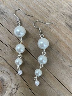 These earrings are made with white glass Pearl beads White Pearl Clip-on Earrings For Party, Handmade White Dangle Clip-on Earrings, Adjustable Nickel-free White Crystal Earrings, Pearl White Dangling Bead Earrings, Pearl Beaded Drop Earrings For Pierced Ears, White Dangle Clip-on Earrings, Pearl White Dangle Earrings With Beads, White Pearl Beaded Drop Earrings, White Pearl Drop Beaded Earrings