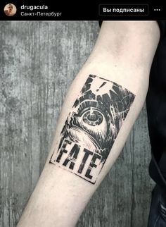 a man's arm with a black and white tattoo on it that reads fate