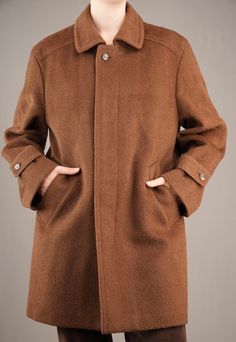 A beautiful male 90's coat by Valmeline. The warm brown wool fabric is similar to that of Loden coats, with slightly long and coarse fibers. It feels thick and sturdy, keeping you warm in those cold winter days. The inside checkered wool lining feels soft and not itchy at all. The coat is in mint condition, there are no damages whatsoever.  While it is a male coat, I would also recommend it to women that like a bit of an androgynous look. I am 175cm (5.9ft) tall and usually wear a female size M. Single Breasted Brown Pea Coat For Winter, Brown Single-breasted Pea Coat For Winter, Brown Wool Coat For Fall Cold Weather, Brown Wool Coat For Cold Weather In Fall, Brown Pea Coat For Winter, Brown Long Pea Coat For Winter, Brown Pea Coat For Cold Winter Weather, Brown Winter Pea Coat For Cold Weather, Brown Wool Coat With Button Closure