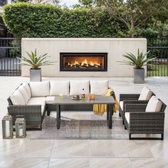 an outdoor living area with furniture and fire place