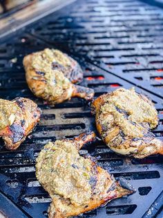 four steaks cooking on an outdoor grill