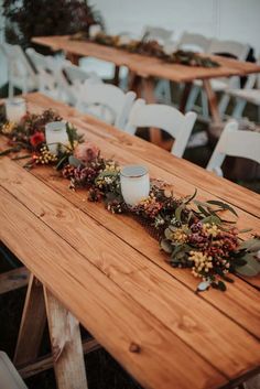 a long table with candles and flowers on it