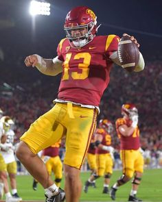 a football player throwing a ball on top of a field