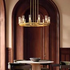 a chandelier hanging over a table in a room with wood paneled walls