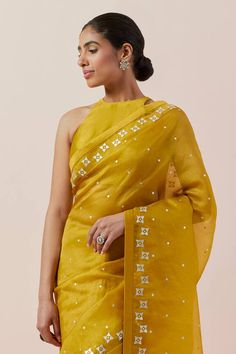 Mustard yellow saree in silk organza base with silver and gold aari and sequin work. Paired with a halter neck blouse and petticoat. - Aza Fashions Gold Pre-draped Saree With Gota Work In Organza, Gold Chanderi Pre-draped Saree With Gota Work, Gold Organza Pre-draped Saree For Navratri, Transitional Gold Pre-draped Saree With Gota Work, Gold Organza Pre-draped Saree With Gota Work, Yellow Pre-draped Saree With Sheer Dupatta, Yellow Cutdana Raw Silk Blouse Piece, Gold Pre-draped Chanderi Saree With Gota Work, Yellow Chanderi Pre-draped Saree With Resham Embroidery