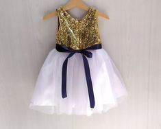 Gold and navy blue flower girl dress Flower girl tutu gold | Etsy Elegant Gold Glitter Tulle Dresses, Gold Glitter Tulle Dress For Dress-up, Gold Sequin Dress For Dress-up Occasions, Gold Sequin Dress For Dress-up, Gold Sequined Dresses For Dress-up Occasions, Gold Sequined Princess Dress For Wedding, Elegant Wedding Tutu Dress With Sequins, Elegant Gold Princess Dress With Sequins, Gold Tutu Dress With Sequins For Dress-up