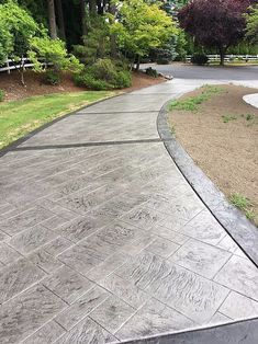 a skateboarder is riding down a paved path