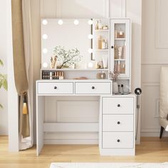 a white dressing table with drawers and lights on it in a room next to a chair