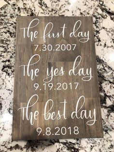 a wooden sign that says the first day and is on top of a marble counter