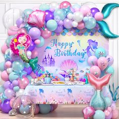 a mermaid themed birthday party with balloons and decorations