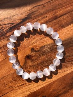 This is a Selenite crystal bracelet for cleansing. It can be used for general cleansing or aura cleansing. The bracelet comes in five sizes, so you can choose the size that fits you best. The size of the beads is 8mm, and the string is a strong 1mm cord that holds its shape well and is less prone to breaking.  Selenite is a crystal well-known for its cleansing and purifying properties. It can cleanse and recharge other crystals and even cleanse your aura. Selenite can also opens and clear the up Selenite Bracelet, Cleanse Your Aura, Energy Blocks, Aura Cleansing, Selenite Crystal, How To Make Box, Spring Hill, Third Eye Chakra, Crown Chakra