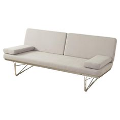 a white couch sitting on top of a metal frame