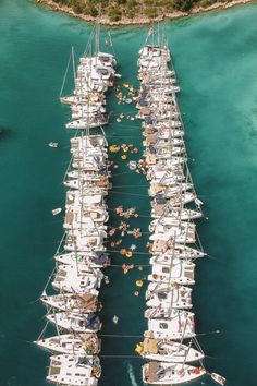 several boats are docked in the water near each other