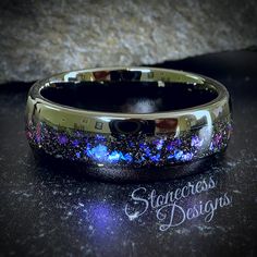 a wedding band that has been decorated with blue and purple glitters on the inside