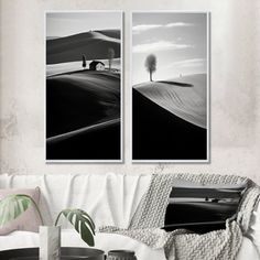 two black and white pictures hanging on the wall above a couch in a living room